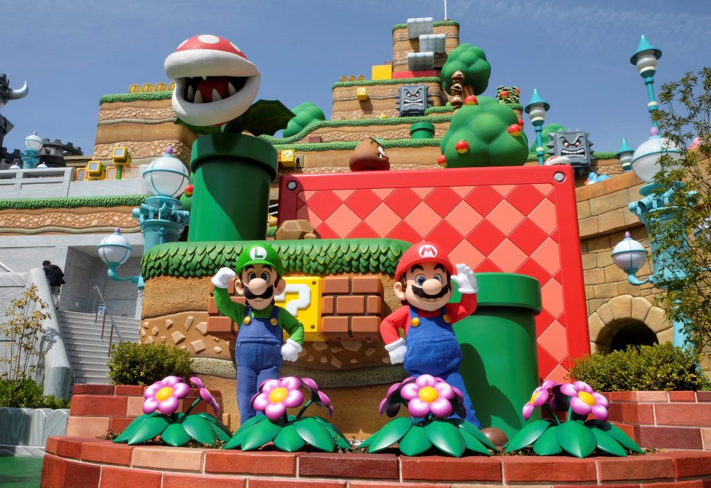Mario and Luigi characters greet visitors in front of Yoshi's Adventure attraction inside Super Nintendo World. (Reuters)