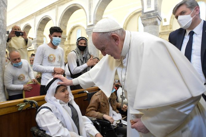 Pope Francis arrives to hold a mass at the Grand Immaculate Church, in Qaraqosh. (Reuters)