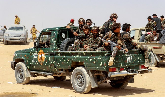 Soldiers ride on the back of a patrol truck during the burial of Brigadier General Abdul-Ghani Shaalan, Commander of the Special Security Forces in Marib who was killed in recent fighting with Houthi fighters in Marib, Yemen February 28, 2021. (REUTERS)