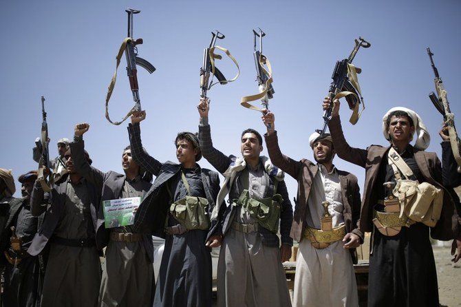 Houthi fighters hold their weapons as they chant slogans during a gathering showing support for the Houthi movement, in Sanaa, Yemen. (File/AP)