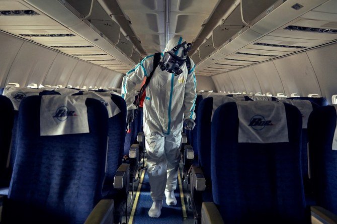 Above, airport staff disinfect a plane after it landed at Juba International Airport in Juba, South Sudan. South Sudan Supreme Airline crashed on March 2, 2021 killing all passengers and crew. (AFP file photo)