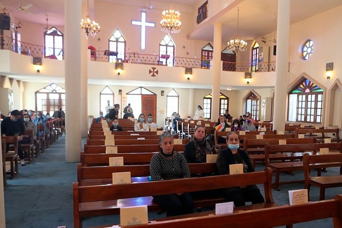Iraqi Christians gather at the Church of the Virgin Mary before going to the airport to welcome Pope Francis in Baghdad on Friday, March 5, 2021. (AP)