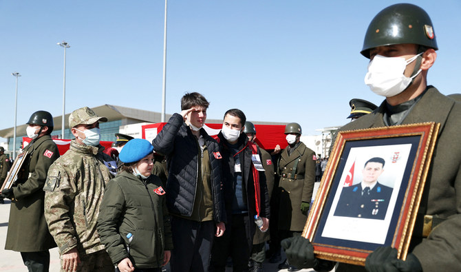 Relatives mourning during a military farewell ceremony for the Turkish soldiers killed in a helicopter crash in Bitlis, on the tarmac of the Elazig airport. (AFP)