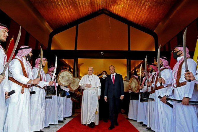 Prime Minister Mustafa Al-Kadhimi receives Pope Francis upon his arrival in Baghdad. (Iraqi prime minister’s office Facebook page via AFP)