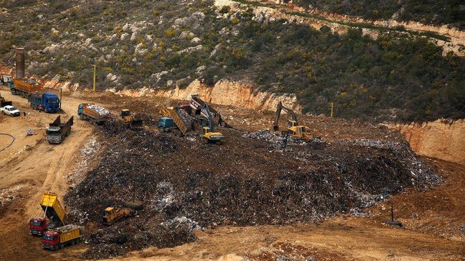 A general view shot taken on March 30, 2016, shows trucks dumping their load at the Naameh landfill, just south of the Lebanese capital, Beirut. (AFP)
