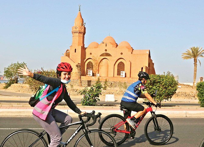 Saudi cyclist Maya Jambi rides her bicycle past the Corniche Mosque in Jeddah on Saturday. The event was held to observe International Women’s Day. (AP)