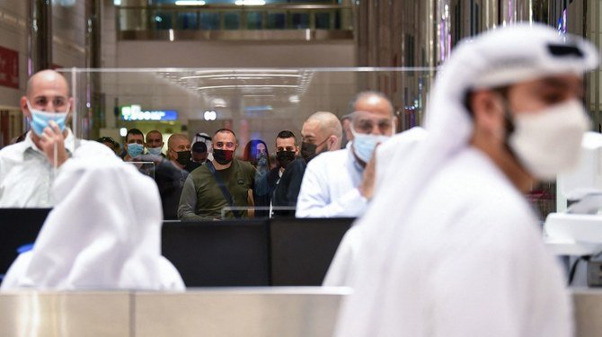 Israelis present their passports for control upon arrival from Tel Aviv to the Dubai airport in the UAE, on Nov. 26, 2020. (File/AFP)