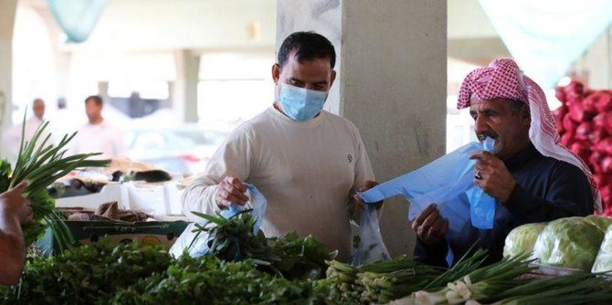 A many buys vegetables in Qatif. (Reuters)