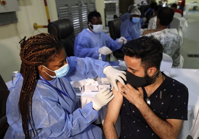 A healthcare worker administers a shot of China's Sinopharm COVID-19 vaccine to a man at the Guru Nanak Darbar Gurudwara (Sikh temple) in Dubai on February 28, 2021. (File/AFP)