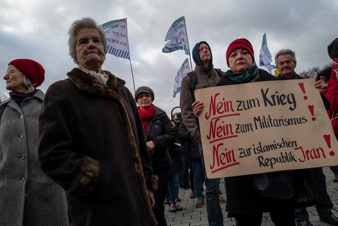 A protester displays a placard reading: 