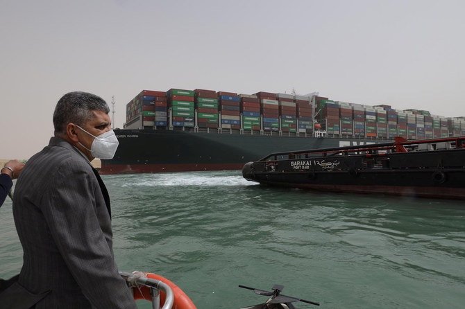 Osama Rabie, Chairman of the Suez Canal Authority, monitors the situation near stranded container ship Ever Given, one of the world's largest container ships, in the Suez Canal, March 25, 2021. (Reuters)
