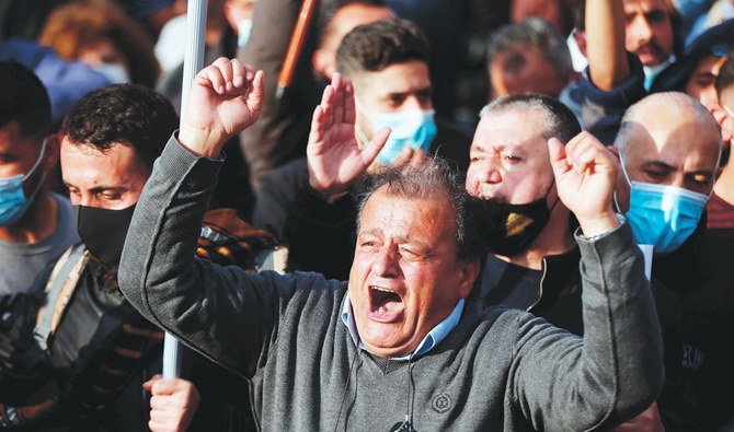 Lebanese soldiers block protesters on the road leading to the Presidential Palace in Beirut on Saturday amid unrest over a steep depreciation of the currency. (AFP)