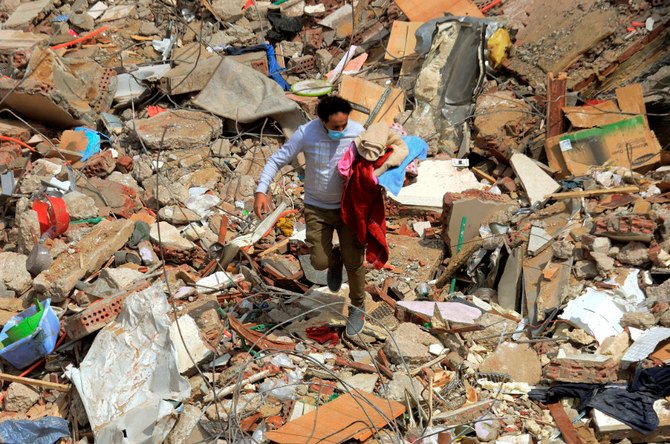 A man walks on the rubble of a collapsed apartment building in the el-Salam neighborhood, in Cairo on March 27, 2021. (File photo/AP Photo)