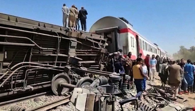 Screengrab provided by AFPTV shows people gathered around the wreckage of two trains that collided in the Tahta district of Sohag province. (File/AFP)