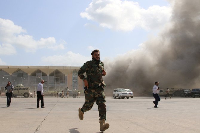 A security personnel and people react during an attack on Aden airport moments after a plane landed carrying a newly formed cabinet for government-held parts of Yemen, in Aden, Yemen December 30, 2020. (Reuters)