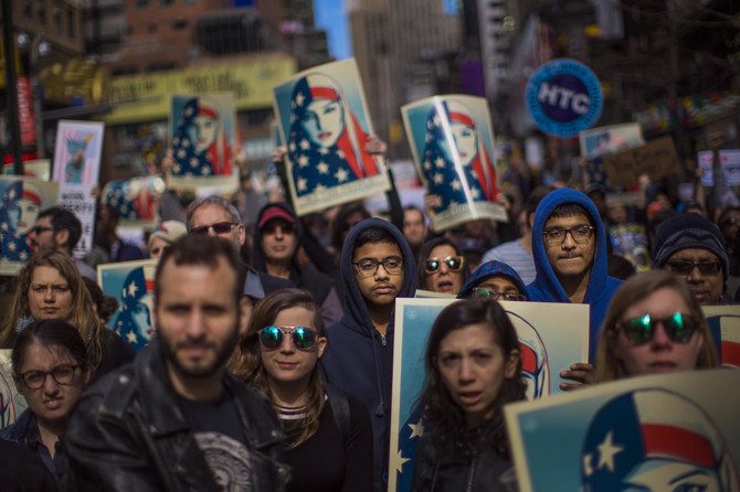 People rally in support of Muslim Americans and in protest at Donald Trump’s immigration policies in Times Square, New York, Feb. 19, 2017. (AP Photo)