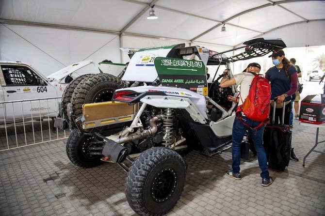 Dania Akeel, the first ever Saudi female to tackle an international rally, stands next to her vehicle in Saudi Arabia for the Sharqiyah International Baja Toyota. (Toyota Rally Media Office/AFP)