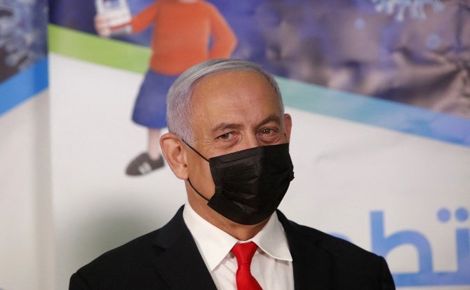 Israeli Prime Minister Benjamin Netanyahu gestures during a visit at a Clalit Health Service COVID-19 vaccination centre, in an Arab-Israeli village of Abu Ghosh near Jerusalem on March 9, 2021. (File/AFP)