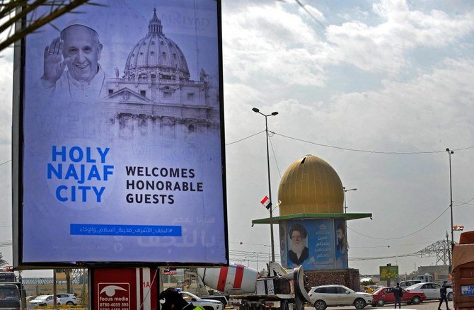 Banners celebrating Pope’s visit to Iraq are on display on March 4, 2021 in Iraq’s holy city of Najaf. (AFP)