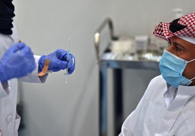 A Saudi citizen prepares to receive the first Pfizer-BioNTech COVID-19 vaccine in Riyadh on Dec. 17, 2020. (AFP)