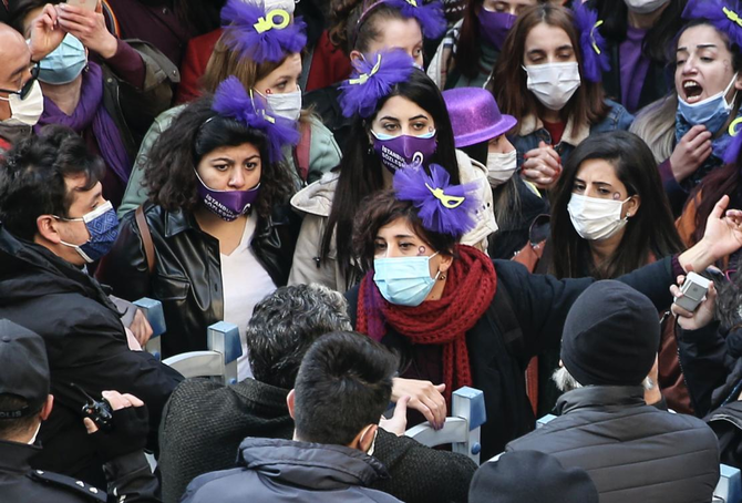 Protesters chant slogans in front of police officers during a rally to mark International Women's Day in Istanbul. (File/AP)