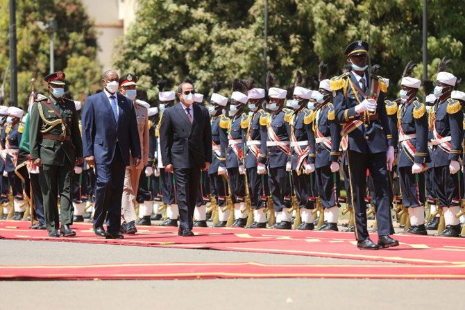 Sovereign Council Chief General Abdel Fattah Al-Burhan walks with President Abdel Fatah El-Sisi, during a welcome ceremony in Khartoum, Sudan March 6, 2021. (Reuters)