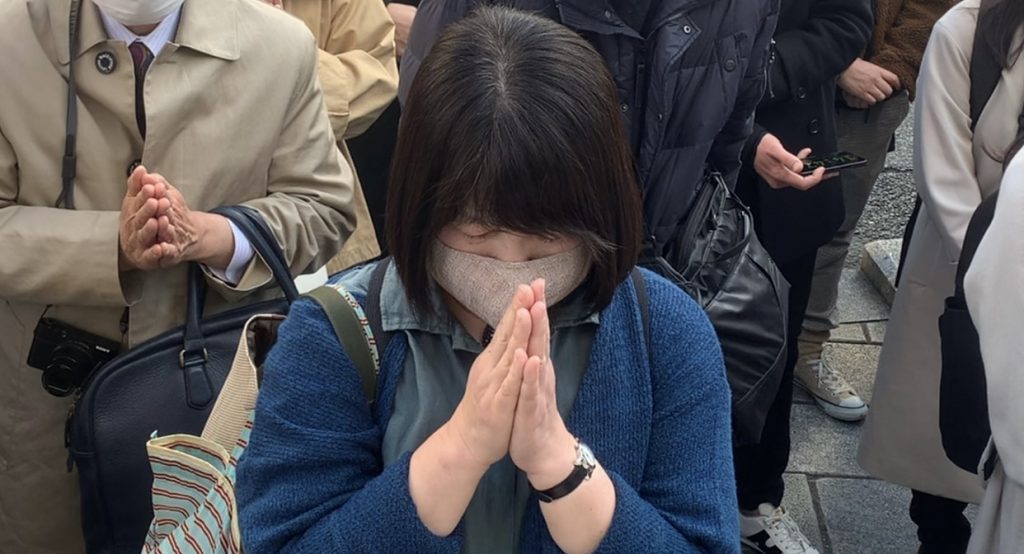 People gathered in front of the Wako department store in Ginza district central Tokyo, observing a moment of silence, March. 11, 2021. (ANJP Photo)