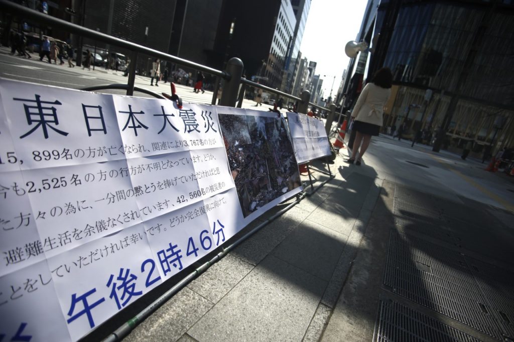 People gathered in front of the Wako department store in Ginza district central Tokyo, observing a moment of silence, March. 11, 2021. (ANJP Photo)