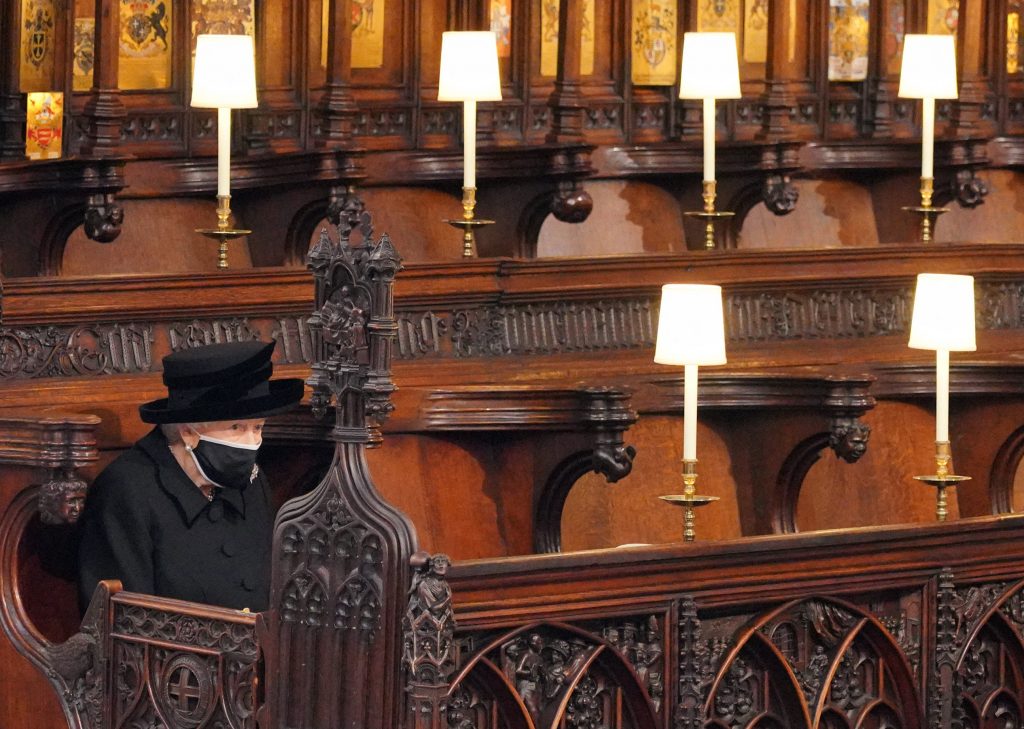 Queen Elizabeth II takes her seat for the funeral service of Britain's Prince Philip, Duke of Edinburgh inside St George's Chapel in Windsor Castle in Windsor, west of London, on April 17, 2021. (AFP)