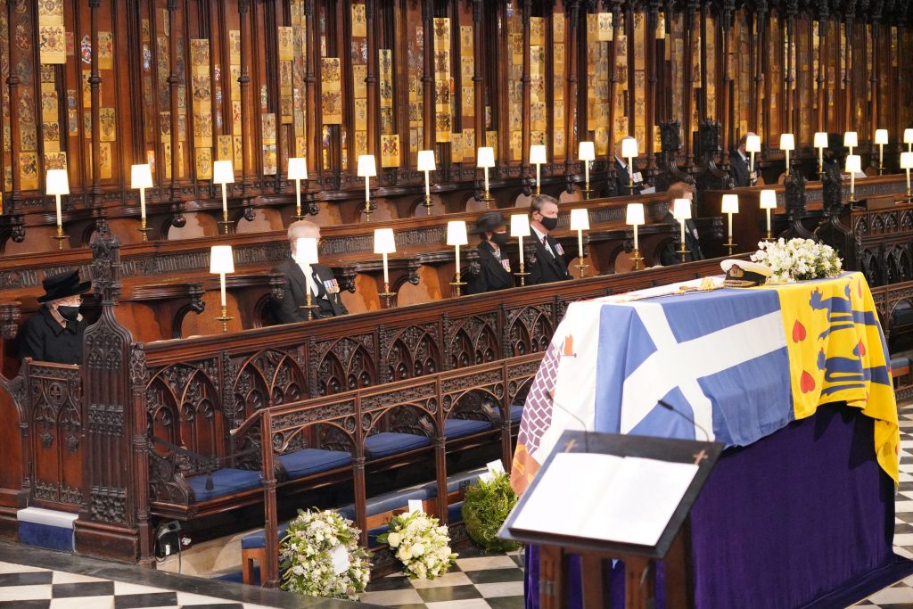 Queen Elizabeth II looks at the coffin of Britain's Prince Philip, Duke of Edinburgh during his funeral service at St George's Chapel in Windsor Castle in Windsor, west of London, on April 17, 2021. (AFP)