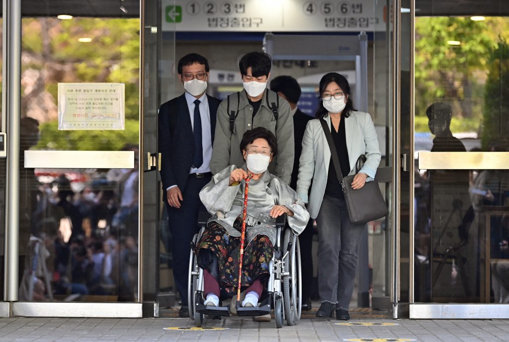 Former South Korean 'comfort woman' Lee Yong-soo (C), who was forced to serve as a sex slave for Japanese troops during World War II, leaves after a court ruling of the 'comfort women' case against the Japanese government. (AFP)