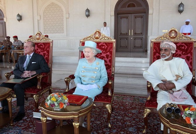 Britain’s' Queen Elizabeth II and her husband Prince Philip (L) attends an equestrian show which included the Omani Royal Cavalry in the presence of Oman’s leader Sultan Qaboos bin Said (R) at Madinat al-Hidayat on November 27, 2010. (AFP/File Photo)