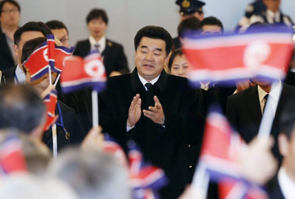 Kim Il Guk, North Korea's sports minister and the president of the Olympic Committee of North Korea is greeted by North Korean residents in Japan upon his arrival at Tokyo's Haneda airport. (Kyodo via Reuters)