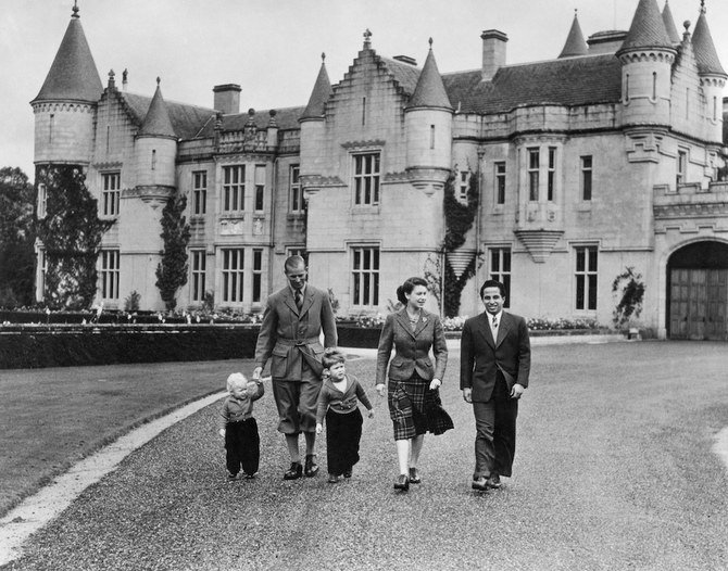 The British Royal Family walk in the park of Balmoral castle along with King Feisal II of Iraq, on September 26, 1952. (AFP/File Photo)