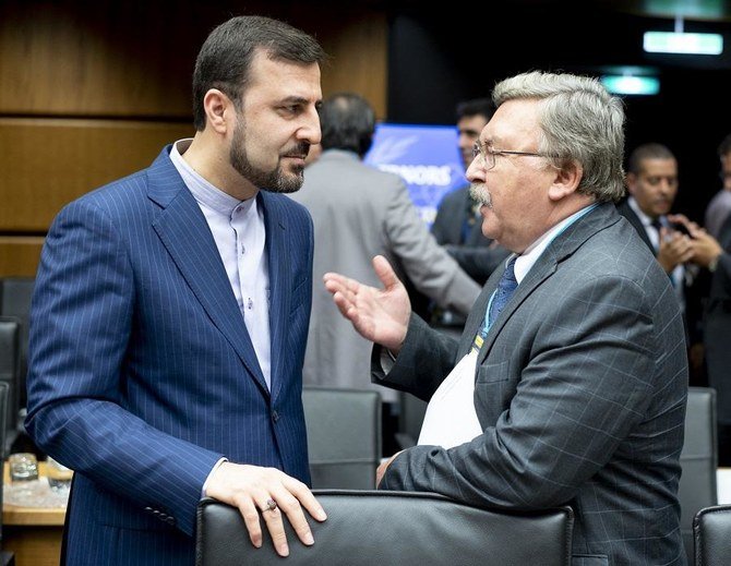 Recently appointed Iran's governor to IAEA Kazem Gharib Abadi speaks to his Russian counterpart Mikhail Ulyanov at the IAEA headquarters in Vienna, Austria on September 10, 2018. (File/AFP)