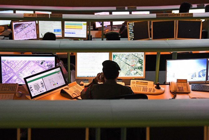 Police officers monitor the streets and receive calls from citizens at the Command and Control Center of Dubai Police in the Gulf emirate, on February 24, 2020. (File/AFP)