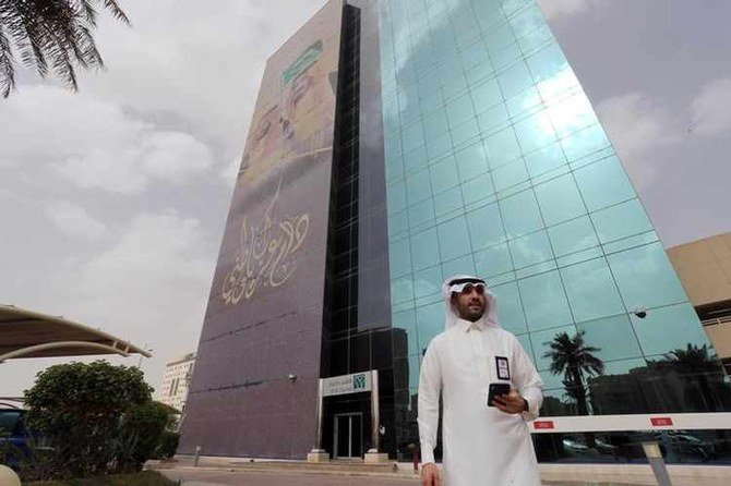 A Saudi man walks outside the Saudi National Commercial Bank (NCB), after a coronavirus outbreak, in Riyadh, Saudi Arabia, March 18, 2020. (File/Reuters)