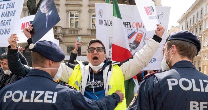 Protesters of the National Council of Resistance of Iran, an Iranian opposition group, in front of the 'Grand Hotel Wien' during the closed-door nuclear talks with Iran in Vienna on April 9, 2021. (AFP)