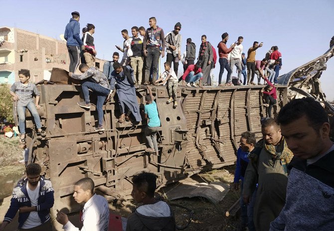 Egyptians gather around mangled train carriages at the scene of a train accident that killed at least 18 people and wounded 200 in Sohag, Egypt. (AP/File)