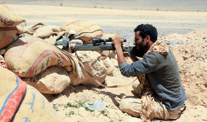 A fighter loyal to Yemen’s legitimate government holds a position against Houthi rebels in Marib. (AFP)