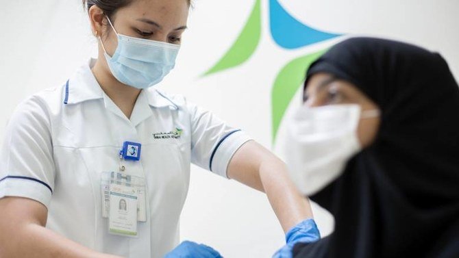 A woman receives a coronavirus vaccine. (WAM)