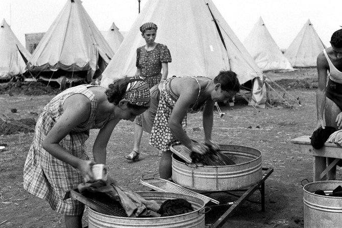 A picture dated March 1, 1940 shows new immigrants wahing their laundry at the immigrants camp near Kibbutz Na'an. (AFP/File Photo)