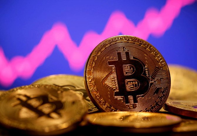 A representation of virtual currency Bitcoin is seen in front of a stock graph. (Reuters)