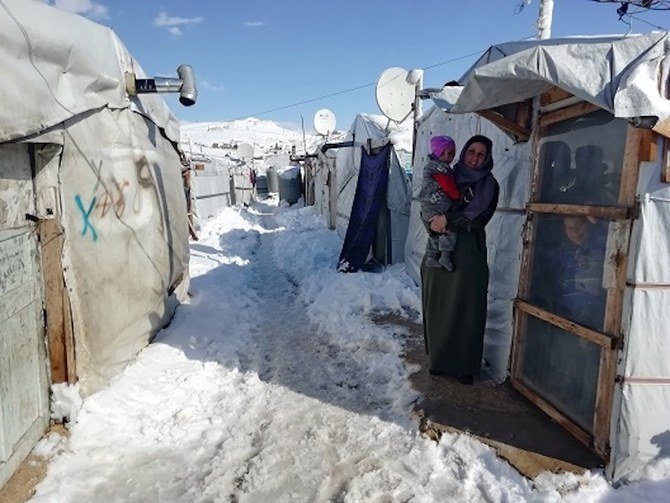 A Syrian refugee woman and child in a makeshift camp near the Lebanese border town of Arsal, Lebanon, January 9, 2019. (Reuters)