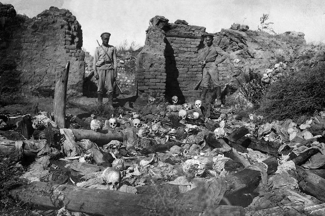 Soldiers stand over skulls of Armenian victims of Ottoman violence on the Caucasus front during the World War I in 1915. (Armenian Genocide Museum-Institute photo via AFP)
