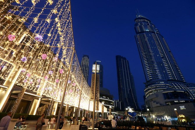 People walk outside The Dubai Mall in the UAE, where the median growth forecasts were raised in a poll. (Reuters)
