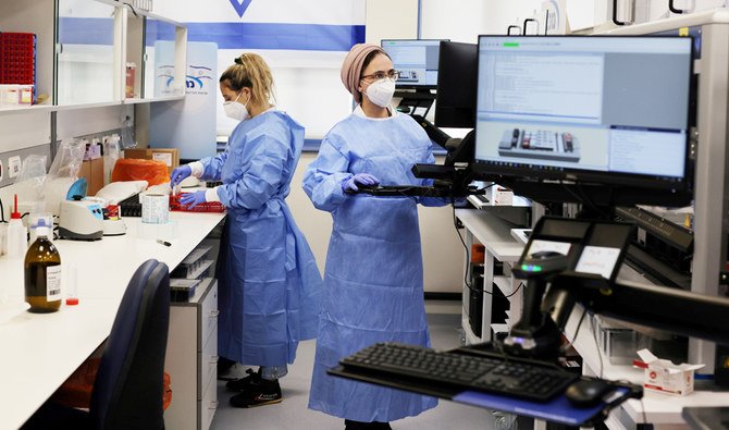 Technicians work at Healthcare Maintenance Organization (HMO) Maccabi's coronavirus disease (COVID-19) public laboratory, performing diverse and numerous tests, in Rehovot, Israel February 9, 2021. (REUTERS)