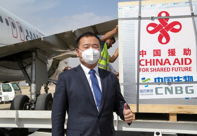 A member of the Chinese delegation gestures as a batch of China's Sinopharm coronavirus disease (COVID-19) vaccine arrives as a donation at the airport in Damascus, Syria April 24, 2021. (Reuters)