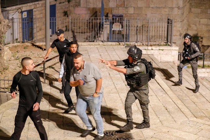 Israeli security forces disperse Palestinian protesters outside the Damascus Gate in Jerusalem's Old City on April 23, 2021. (AFP)