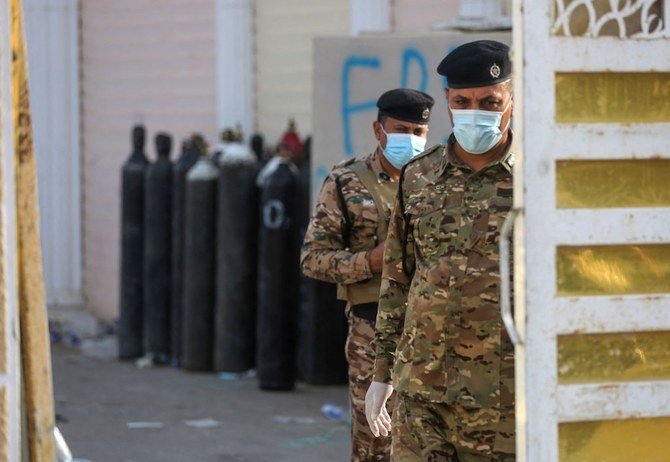 Iraqi policemen stand at the gate of Ibn Al-Khatib Hospital in Baghdad, on April 25, 2021. (AFP)